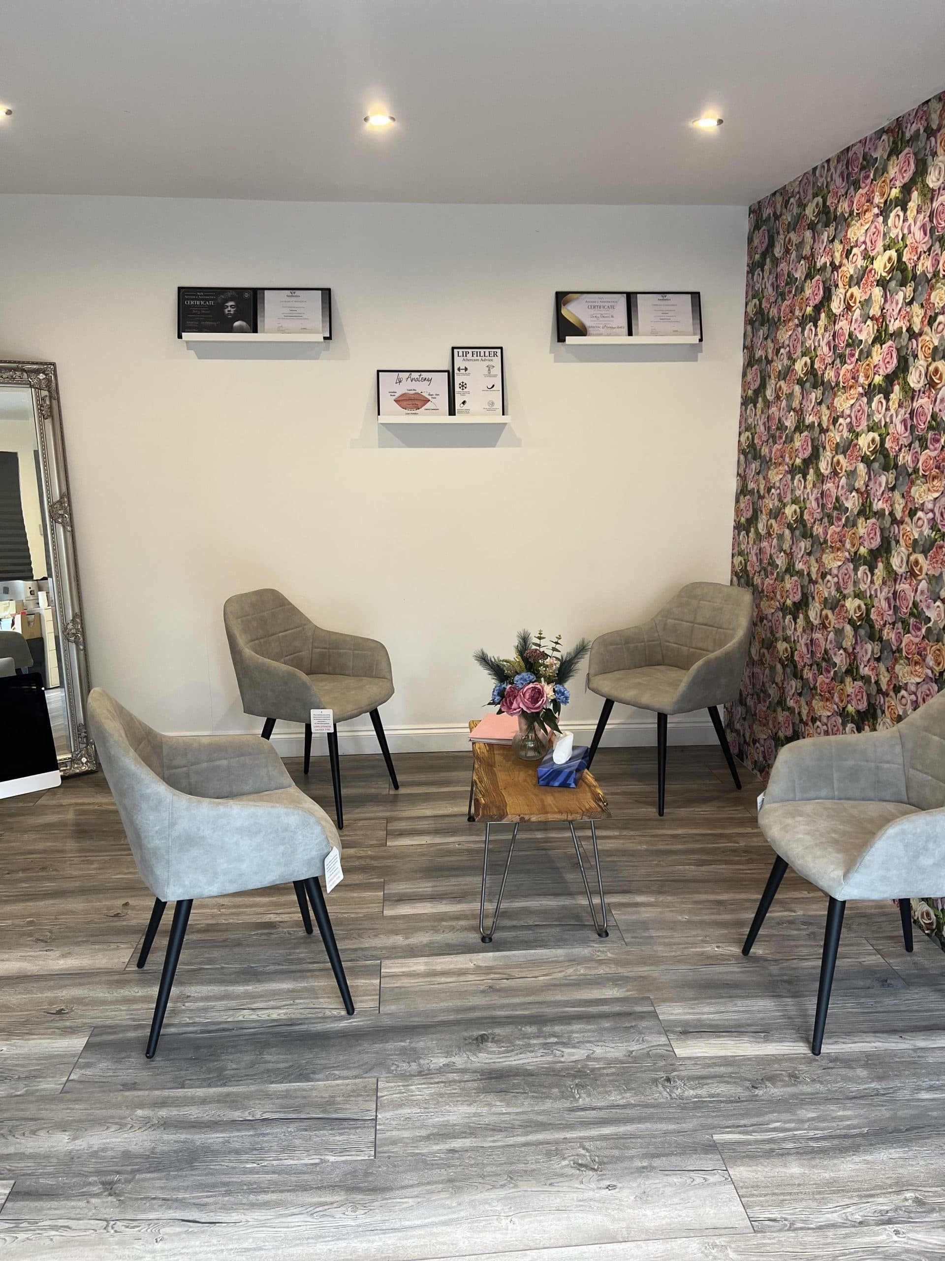 AAH Aesthetics clinic lounge with seating and floral accent wall