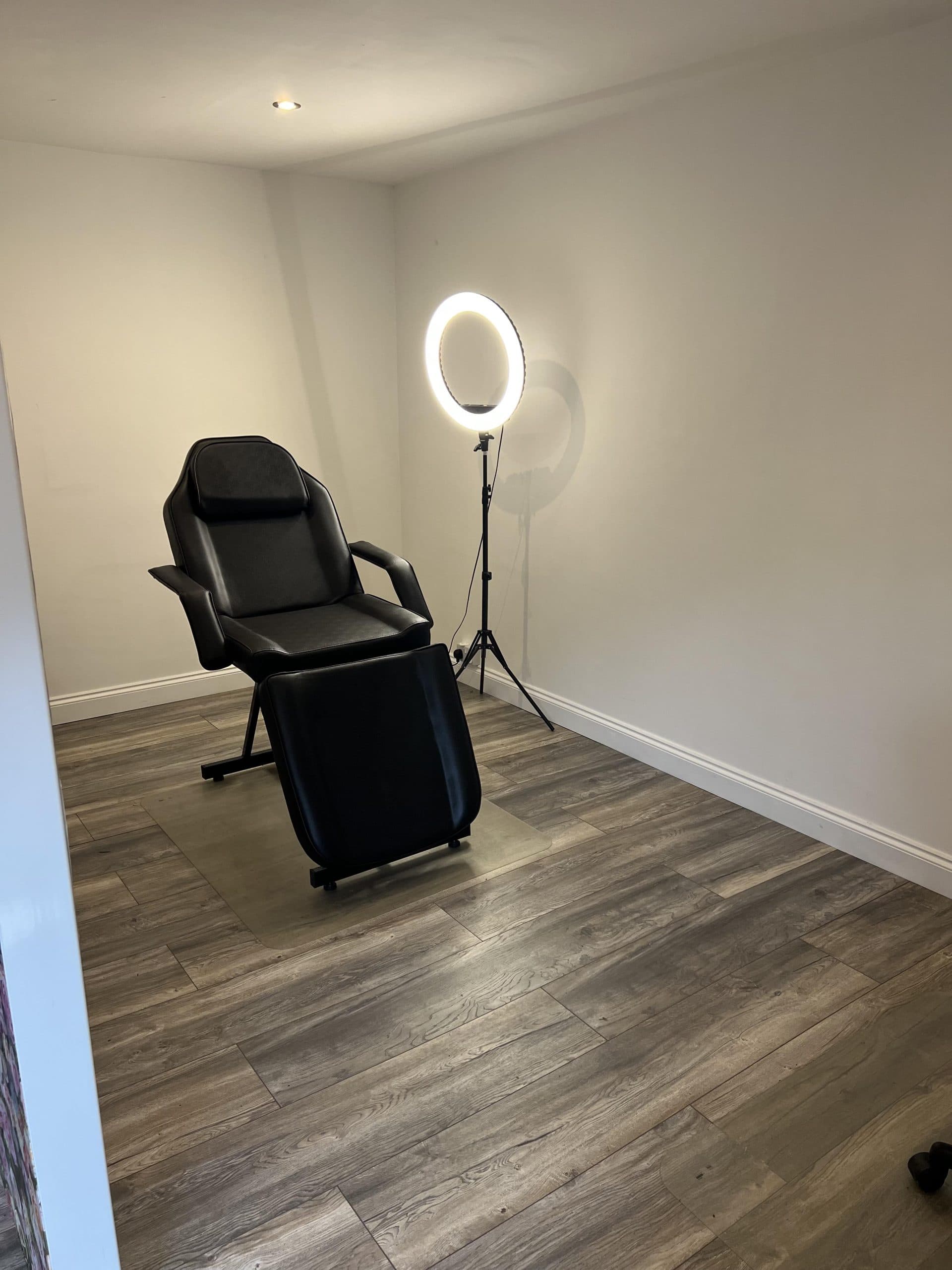 Private treatment room with chair and ring light